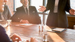© Rawpixel.com - Business meeting with diverse professionals in a sunlit room.