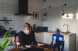 © Johnér - Woman using wireless technologies while sitting at table in home