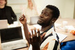 © Johnér - Male entrepreneur asking questions while sitting in office meeting