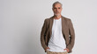 © opolja - Serious middle-aged man posing in front of a grey background with copy space.