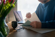 © Johnér - Male entrepreneur reviewing documents while working from home