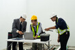 © Leny Studio - Construction team planning laptop hard hat safety vest worksite office meeting project management engineer collaboration
