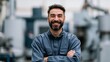 © Andrii Zastrozhnov - Happy bearded factory technician in blue uniform with folded arms in an industrial workshop for staff profile header and manufacturing website background