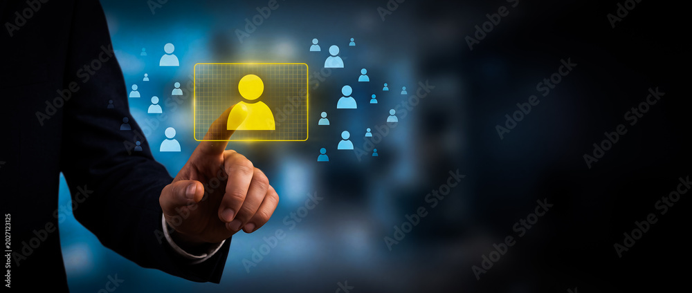 Businessman touching a digital screen with a human icon, representing ...