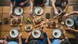© Muhammad - Friends enjoying delicious dinner party with shared food on wooden dining table