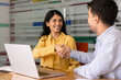 © fizkes - Smiling South Asian businesswoman shaking hands with male colleague during corporate meeting in office. Business agreement, partnership, making deal, successful negotiation result, recruitment concept