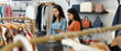 © fizkes - Two young women collaborate at checkout counter inside stylish clothing boutique, working on laptop using digital tablet. Teamwork, customer services, small business management in modern fashion store