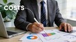 © Jieun - Businessman in suit writing on financial reports with costs text overlay and pie charts for budget planning and expense management