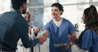 © peopleimages.com - Medical, clap or people in hospital with handshake, promotion or introduction for clinical collaboration. Happy, tech or doctors with applause, achievement or team welcome in healthcare partnership.