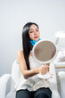 © NINENII - Asian woman consulting with a doctor at a modern aesthetic clinic for facial treatment.