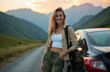 © miss irine - Woman leans on car parked on mountain road at sunset. She wears casual outdoor clothes and backpack, smiling with relaxed confident mood enjoying trip.