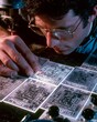 © DigitalSpace - Medium shot of a technician using laser etching equipment to precisely mark electrical receptacle faceplates with detailed symbols and labels.