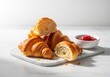 © Mikhail - Freshly baked croissants with cherry jam on a marble board for a classic french breakfast