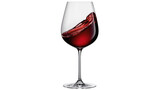Red wine splashing inside a clear glass, isolated on transparent background