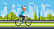 © Al Stok - Man riding a bicycle with a helmet and casual attire.