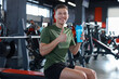© New Africa - Happy young man with protein shake showing thumbs up in gym