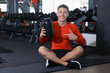 © New Africa - Happy young man with jar of protein powder in gym