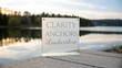 © Sulizi - Elegant glass plaque displaying the words 'Clarity Anchors Leadership' on a serene lakeside during sunset with a calm water reflection and trees