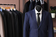 © Pixel-Shot - Shelving unit, rack and mannequin with different stylish male suits in dressing room