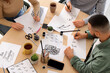 © Pixel-Shot - Group of young people during courses of calligraphy, high view