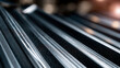 © Denis Yevtekhov - Close-up of a dark corrugated metal roofing panel showing sharp diagonal silver lines and geometric stripe patterns, the abstract industrial texture filling the frame with precision
