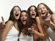 © Salih - Four Friends Laughing Joyfully: A group of four young women sharing a moment of pure joy, their faces alight with laughter and shared amusement.