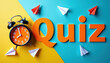 © Vadym - Orange word quiz with alarm clock and paper planes on blue and yellow background. Time for test or game. Education challenge and brain teaser concept.