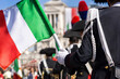 © oliamogdaleva - Italian banner with soldier in dress uniform carrying flag at city festival in Rome. Festa della Repubblica.