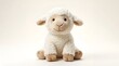 © Purwa - Cute fluffy sheep plush toy sitting on a white background, studio shot