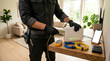 © solom - technician or IT specialist installing a white internet router connecting fiber optic cable on wooden table in living room home broadband setup or maintenance service
