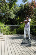 © wavebreak3 - African American man standing stretching arms across chest on deck mat by cable railing, copy space