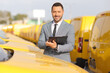 © Ljupco Smokovski - Fleet manager writing on a clipboard