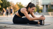 © Sumanta - young woman doing yoga. young woman doing stretching exercise. Close-up low-angle shot of a young athletic woman stretching on a fitness mat outdoors.