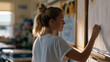 © forenna - Rural elementary teacher decorating classroom bulletin boards with sunflower and wheat motifs for first day of school in an August morning, school supply boxes still taped shut on desks, teacher pre