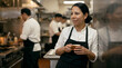 © Andres Mejia - Chef taking a coffee break in busy restaurant kitchen