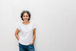 © Westend61 - Smiling mature woman with short hair standing against white wall