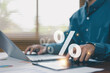 © ภัทรชัย รัตนชัยวงค์ - Business finance and percentage analysis concept with professional using tablet and laptop, representing financial data, investment growth, tax calculation, sales performance and digital analytics.