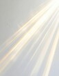 © favor - Diagonal golden light rays stream across a textured white wall