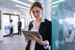 © bulentbaris - Businesswoman using a tablet in a modern office