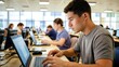 © Marc - A young man intently focusing on his laptop screen in a classroom or computer lab setting, surrounded by other students working on their computers.