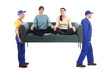 © New Africa - Movers carrying sofa with girls sitting on it against white background