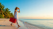 © Ace - Beautiful young woman exploring a tropical beach with her red travel suitcase, perfect for summer vacation getaway concepts