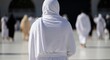 © Nana - Pilgrim in Ihram walking towards Kaaba in Mecca, Hajj pilgrimage, Islamic tradition