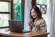 © Farknot Architect - Portrait of a woman using and working on laptop computer at home