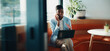 © peopleimages.com - Laptop, office and black woman with phone call for communication, copywriting or opportunity. Discussion, advice and editor talking on mobile, contact or support for online editing in startup agency