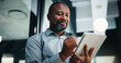 © peopleimages.com - Business, black man and writing with tablet in office for research, court case and legal evidence. Smile, mature lawyer or digital for witness testimony, statement report and confidential information