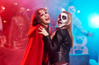 © Westend61 - Women in creepy costumes dancing at Halloween party