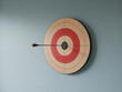 © Syedimtiaz - Archery target with arrow hitting bullseye on wall for business concept and goal achievement
