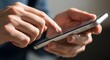 © Khasanah - Close-up of Person's Hands Holding and Interacting with a Modern Smartphone Screen.