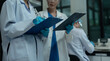 © NINENII - scientist or doctor team with tech for scientific innovation, planning or data report.
